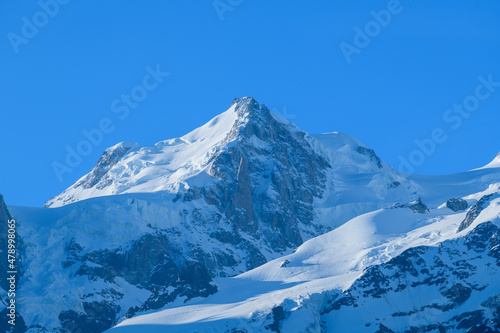 The close-up on Mont Maudit and its eternal snows in the Mont Blanc Massif in Europe, France, the Alps, towards Chamonix, in summer, on a sunny day.