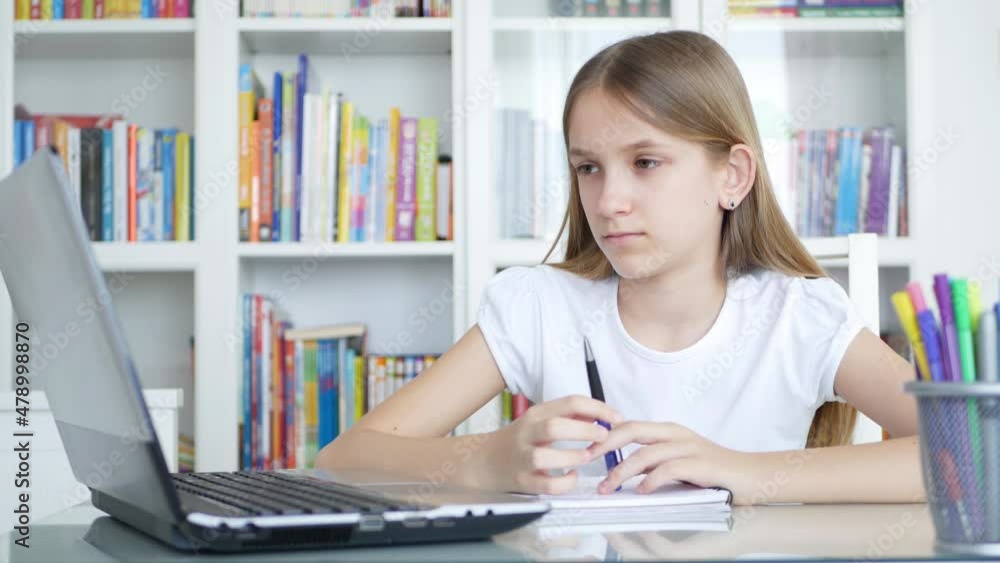 Bored Kid Studying on Laptop for School, Sad Child Working on PC in Office, Student Girl Writing Homework, Online Education Bored Kid Studying on Laptop for School, Sad Child Working on PC in Office, Student Girl Writing Homework, Online Education