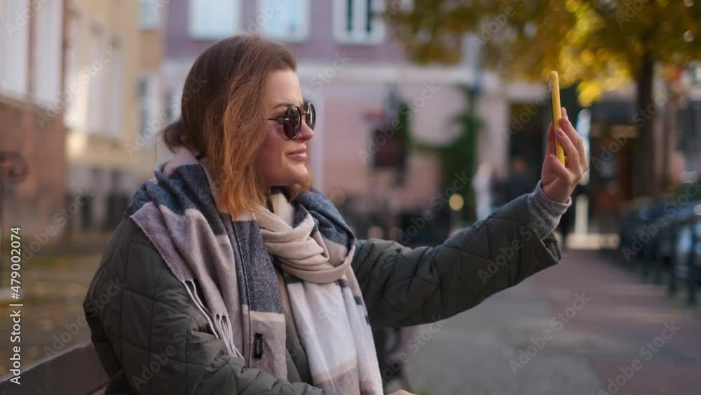 Traveller woman in sunglasses does selfie in the street of old town in autumn, 4k 60p slow motion Traveller woman in sunglasses does selfie in the street of old town in autumn, 4k 60p slow motion