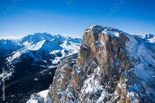 Aerial view of Sass de Stria mountain peak with Marmolada covered with snow in the background, Dolomites, Veneto, Italy photo