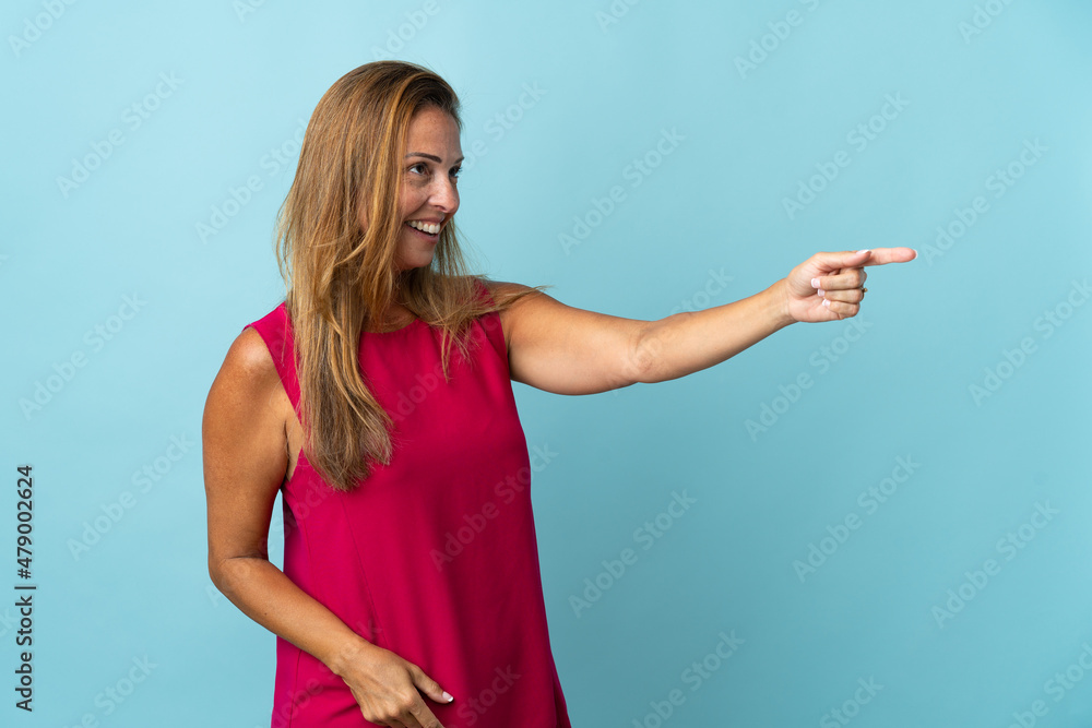Middle age brazilian woman isolated on blue background pointing away Middle age brazilian woman isolated on blue background pointing away
