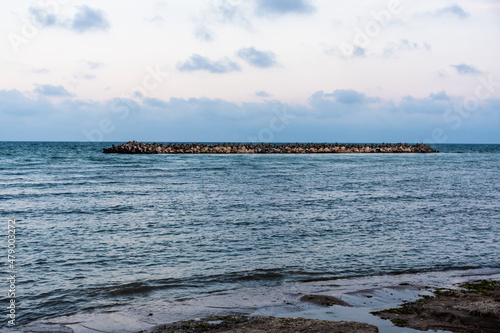 Black sea landscape. Stabilopods, rocks in the seawater. Mangalia, Romania. photo