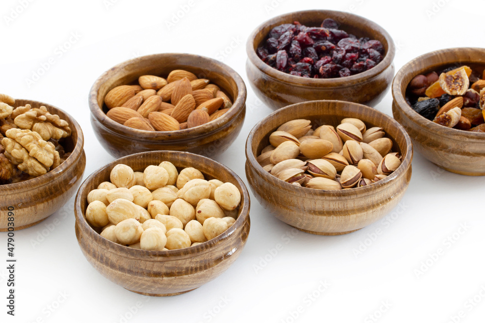 dried fruit and various nuts on plates dried fruit and various nuts on plates