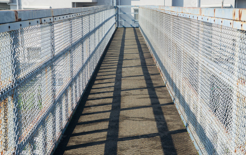 Tablou Canvas pedestrian footbridge on a sunny day with shadows