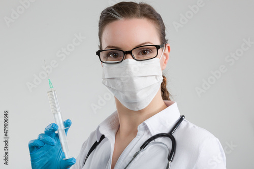 female doctor or nurse with syringe pulled up with a vaccination serum