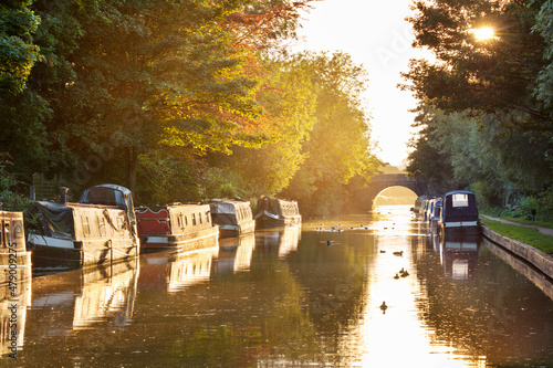 Narrowboats moored on the Kennet and Avon Canal at sunset, Kintbury, Berkshire photo