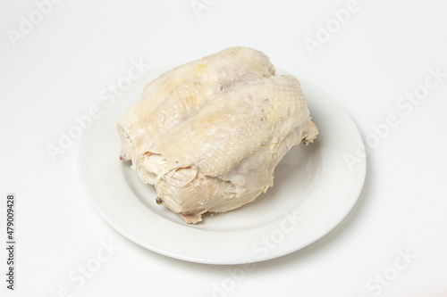 Boiled chicken breast on a white background. Diet meat on a white plate. Healthy diet