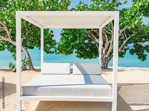 white bed on the sandy beach of the sea