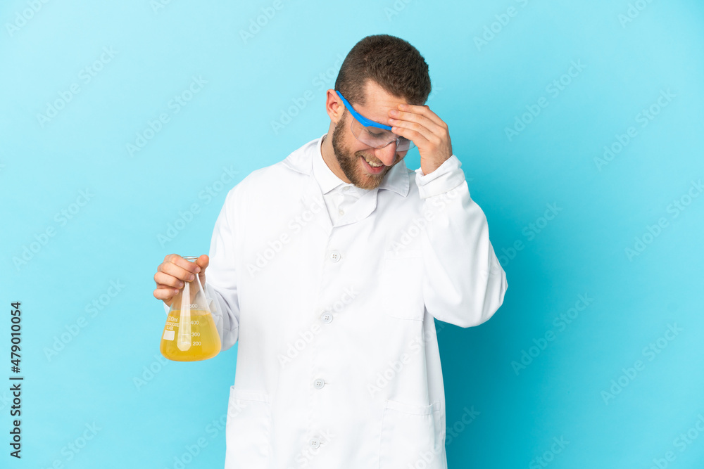 Young caucasian scientific man isolated on blue background laughing Young caucasian scientific man isolated on blue background laughing