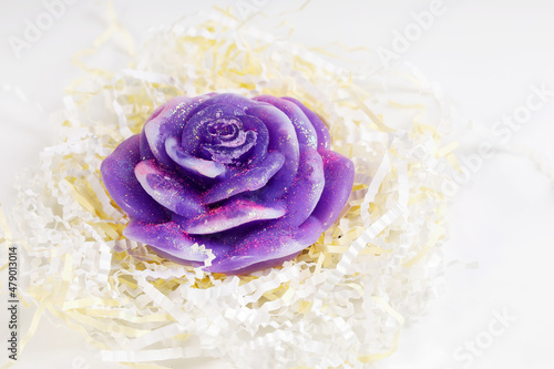 Beautiful purple soap with sparkles  shape rose with packaging ribbons close-up