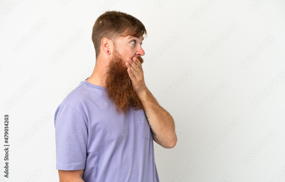 Young reddish caucasian man isolated on white background doing surprise gesture while looking to the side Young reddish caucasian man isolated on white background doing surprise gesture while looking to the side