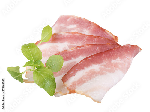 slices of raw bacon with a sprig of fresh basil, isolated on a white background
