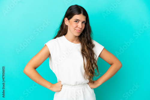Young caucasian woman isolated on blue background angry