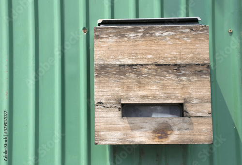 Mail box or Letter box old vintage made of wood on green wall background.