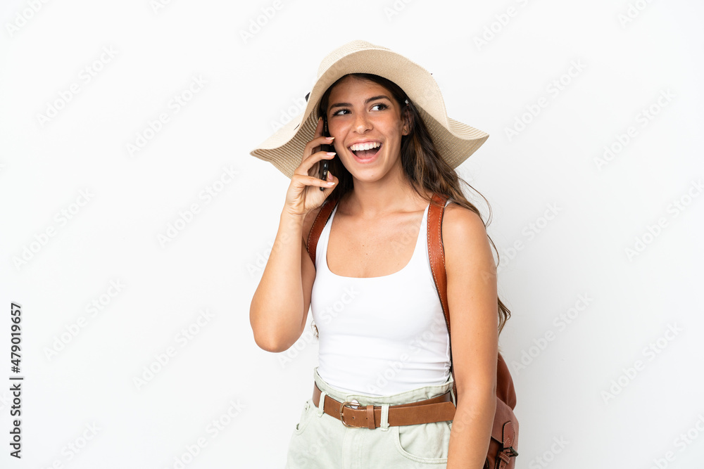 Young caucasian woman wearing a Pamela in summer holidays isolated on white background keeping a conversation with the mobile phone Young caucasian woman wearing a Pamela in summer holidays isolated on white background keeping a conversation with the mobile phone