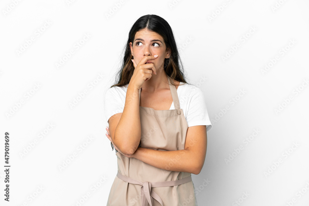 Restaurant waiter over isolated white background having doubts and with confuse face expression Restaurant waiter over isolated white background having doubts and with confuse face expression