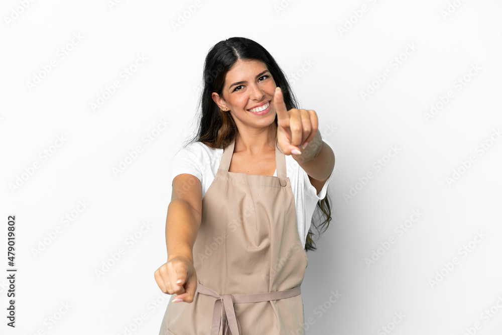 Restaurant waiter over isolated white background points finger at you while smiling Restaurant waiter over isolated white background points finger at you while smiling