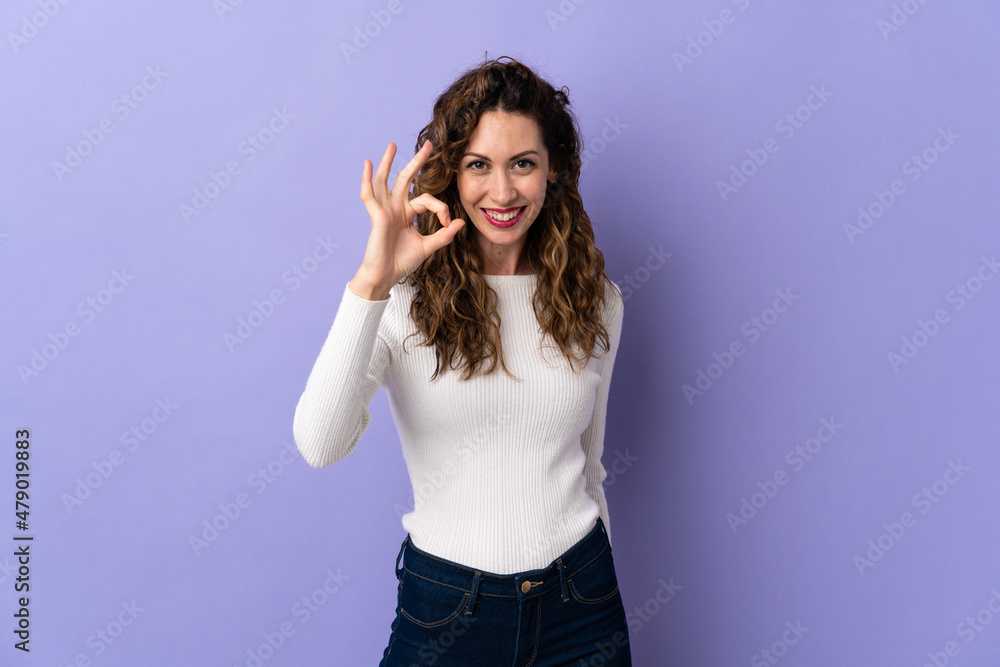Young caucasian woman isolated on purple background showing ok sign with fingers Young caucasian woman isolated on purple background showing ok sign with fingers