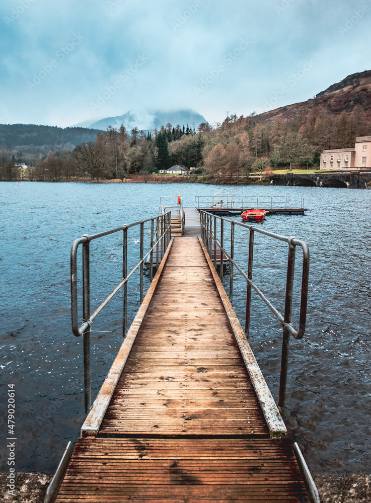 Naklejka premium View down a jetty toward a mountain - Scotland 