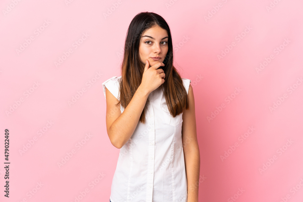 Young caucasian woman isolated on pink background looking up while smiling Young caucasian woman isolated on pink background looking up while smiling
