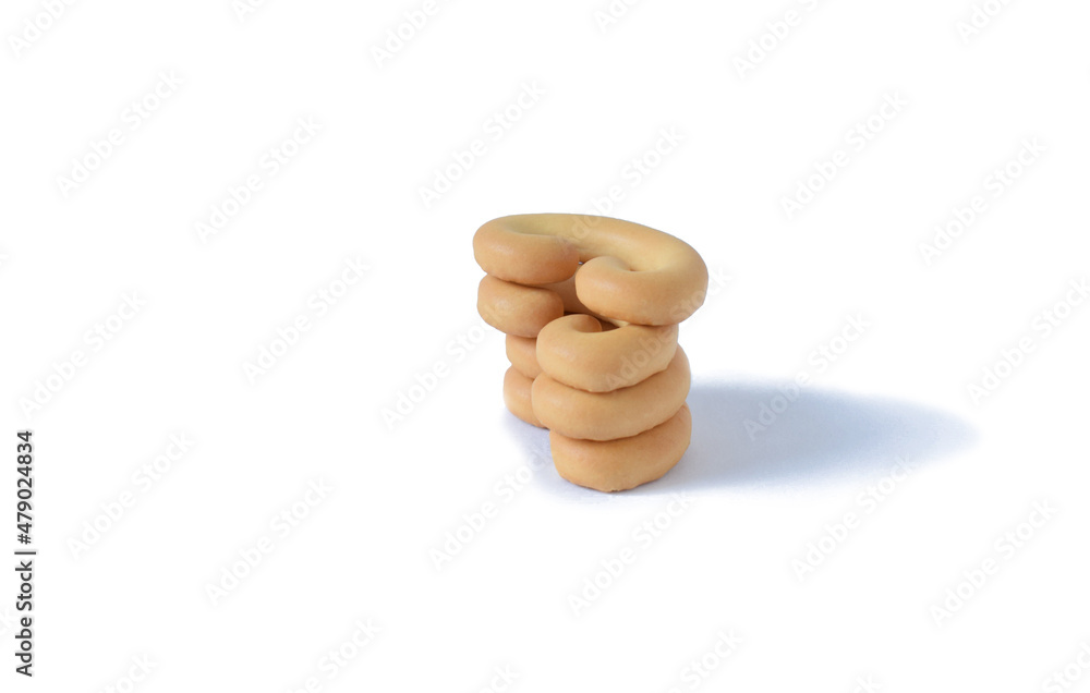 a column of sweet bagels in close-up on a white background.Isolated a column of sweet bagels in close-up on a white background.Isolated