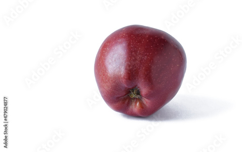 A fresh red apple is highlighted on white. With trajectory cropping. copy space