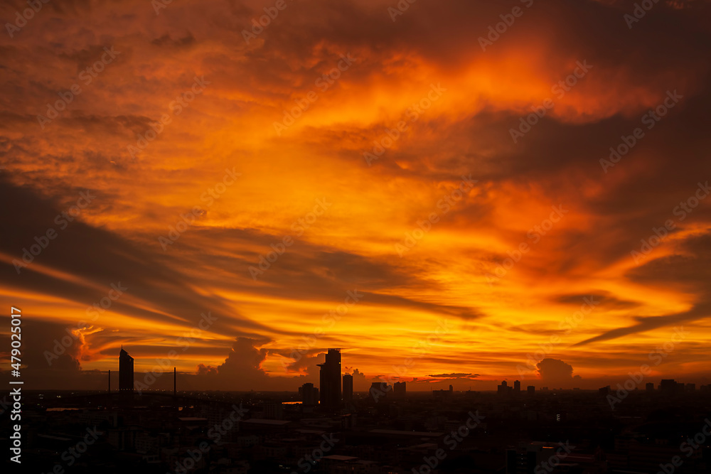 Sunset over the silhouetted cityscape background in a beautiful twilight sky. Sunset over the silhouetted cityscape background in a beautiful twilight sky.