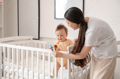 Young mother giving toys to...
