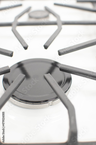 Close-up shoy of a rapid gas burner of a white gas hob photo