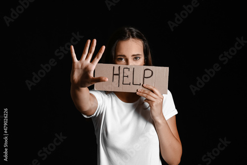 Young woman holding paper w...