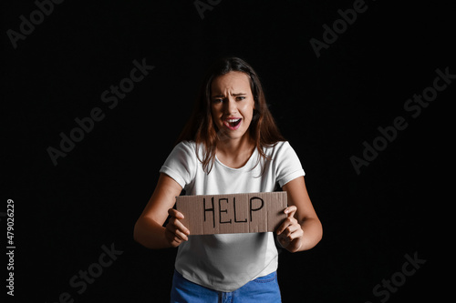 Scared young woman holding ...