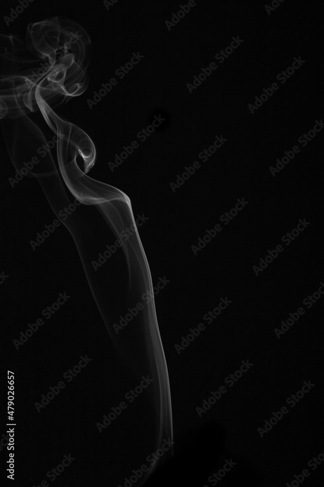 wax candle with burning wick and smoke, isolated on a black background wax candle with burning wick and smoke, isolated on a black background
