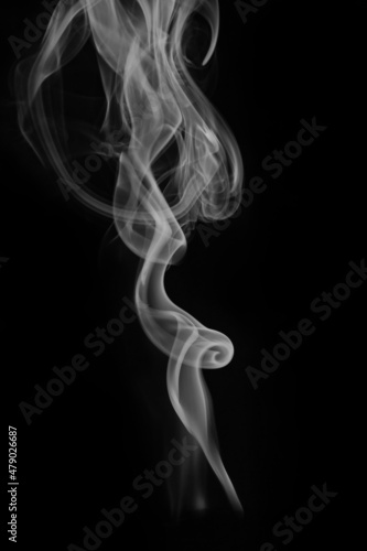 wax candle with burning wick and smoke, isolated on a black background