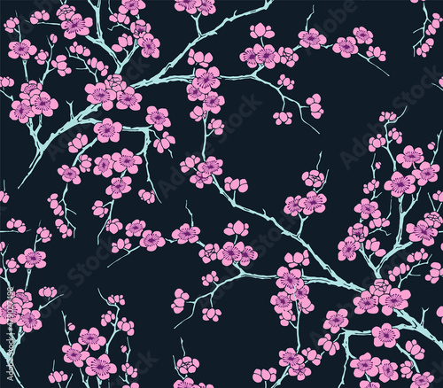 Cherry pink flowers in blossom and branches seamless vector pattern on dark blue background. 