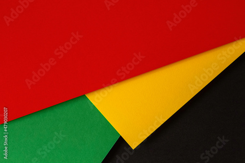 Abstract geometric black, red, yellow, green color paper background. Black History Month color background with copy space for text