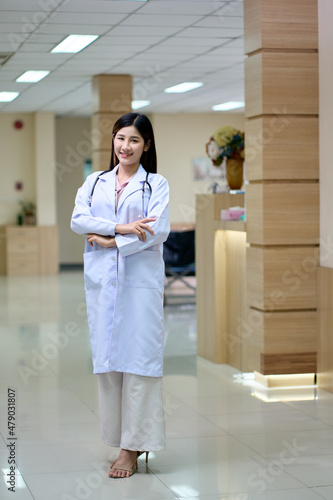 Young asian female dostor portrait in hospital lobby photo
