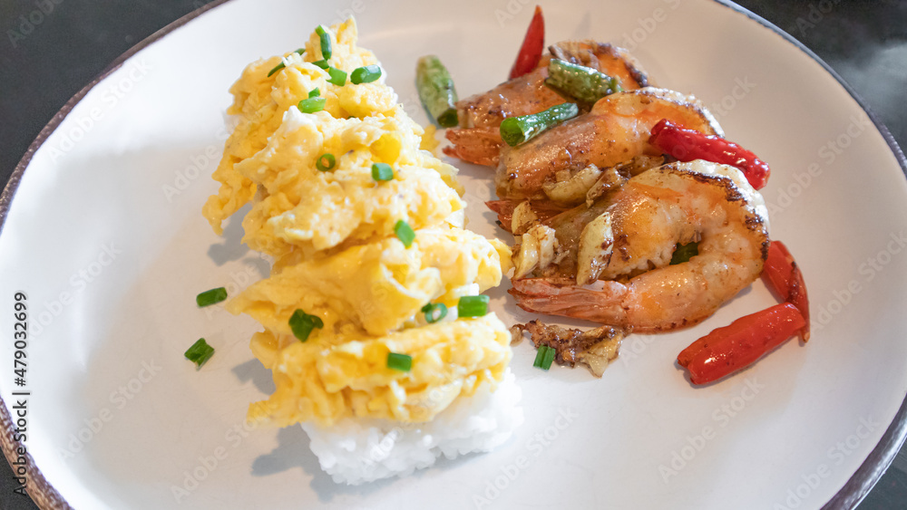 Stir fried crispy shrimp with chilies salt garlic with rice and scrambled eggs. Stir fried crispy shrimp with chilies salt garlic with rice and scrambled eggs.
