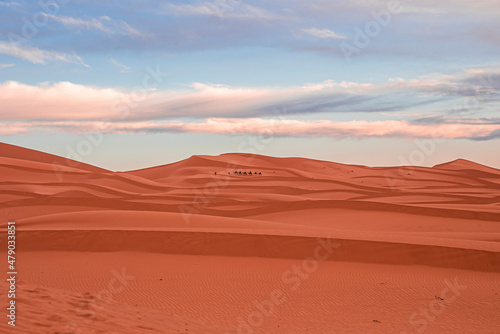 Beautiful view of sand dunes in sahara desert against cloudy sky  Sand dunes with waves pattern in desert