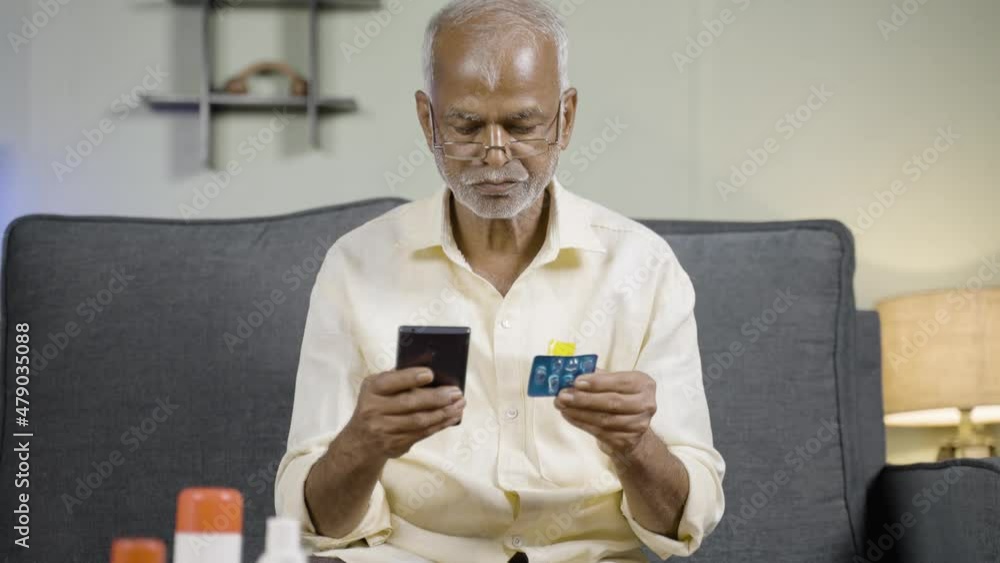 Senior man checking about availability, purchasing or ordering online medicines on mobile phone from home - concept of E-Pharmacy Senior man checking about availability, purchasing or ordering online medicines on mobile phone from home - concept of E-Pharmacy