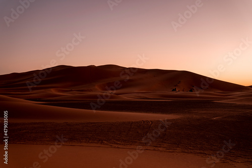 Beautiful view of sand dunes in sahara desert during dusk, Sunset over sand dunes in desert landscape © Aerial Film Studio
