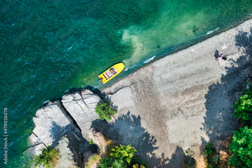 Aerial view from a drone on a beach and a boat, on the coast of the Dniester river in Ukraine, Bakota