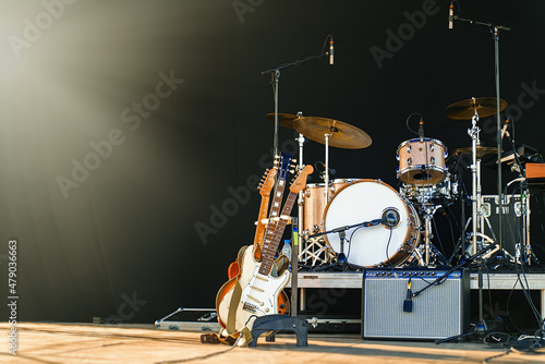 Electric guitars and drum on stage before the concert.