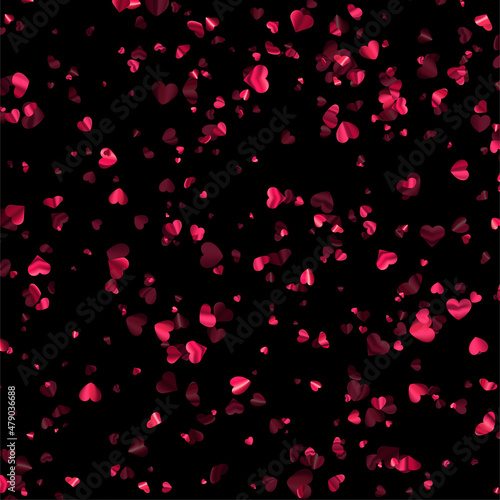 Pink foil hearts confetti on black background.