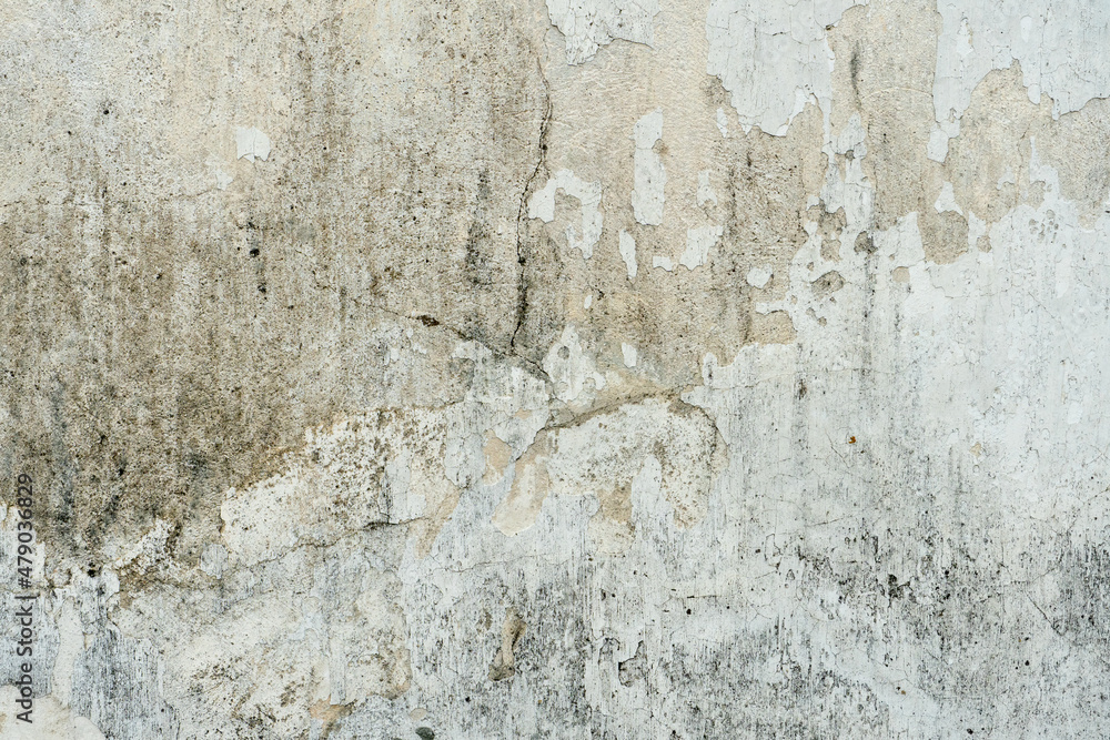 The surface of a concrete wall with old peeling paint. The texture of time-damaged paint. Multi-colored blank background for the design. The surface of a concrete wall with old peeling paint. The texture of time-damaged paint. Multi-colored blank background for the design.