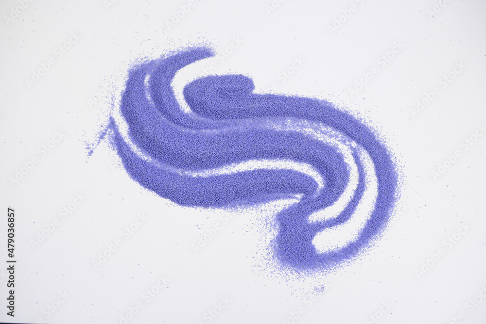 Abstract image of handful of purple coloured sand. Top view on isolated white background. Symbol of Christmas. Color of the year 2022 Very Peri.