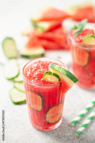 Refreshing cold summer drink watermelon slushie with cucumber slices in glass