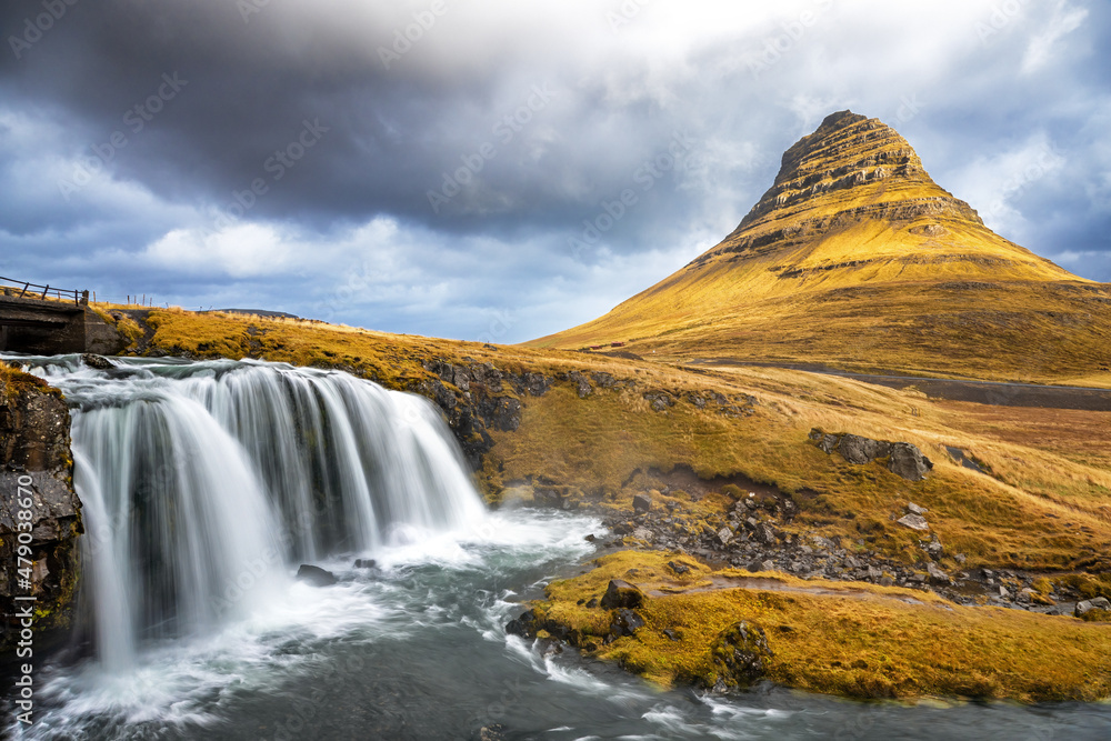 Kirkjufell mountain and Kirkjufellfoss waterfall in autumn, Snaefellsnes peninsula, Iceland. Long exposure shot. Kirkjufell mountain and Kirkjufellfoss waterfall in autumn, Snaefellsnes peninsula, Iceland. Long exposure shot.