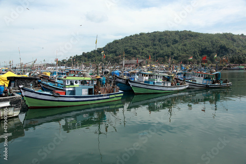 Anchored fishing boats at Baithkol jetty near Karwar, India.