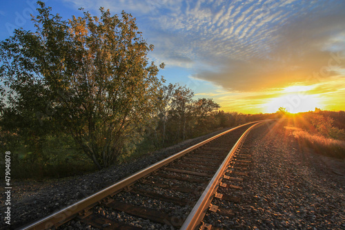 Train Tracks Leading into the Setting Down Sun