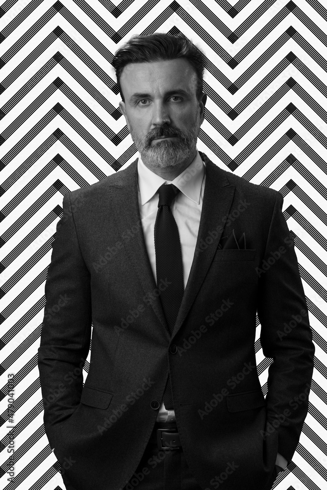 Black and white portrait of a stylish elegant senior businessman with a beard and casual business clothes against retro colorful pattern design background gesturing with hands Black and white portrait of a stylish elegant senior businessman with a beard and casual business clothes against retro colorful pattern design background gesturing with hands